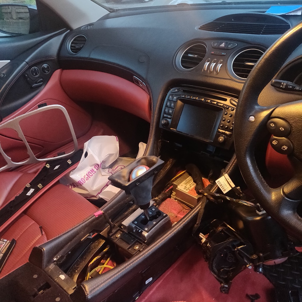 A Mercedes centre console stripped down to expose the wiring and control unit during electrical repair work at Samet Auto Electrics.